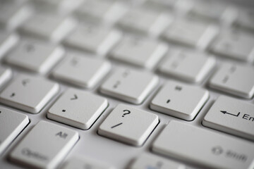 Close-Up of White Keyboard with Focus on Question Mark Key for Technology and Computing Concepts