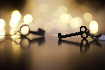 Vintage Skeleton Keys on Reflective Surface with Warm Bokeh Lighting