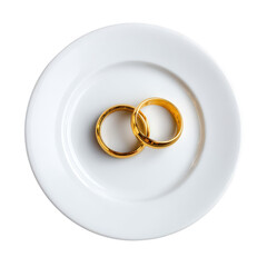 Two elegant gold wedding rings resting on a simple white plate. The composition highlights the symbolic nature of love and commitment, perfect for celebrating special occasions.