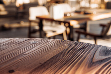 Rustic wooden table in bright cafe environment with soft lighting and blurred background