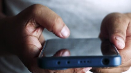 Finger scrolling social media app feed, information search. Keep connected and keep your clients happy. Close up of young scrolling through cell phone social media. - Powered by Adobe