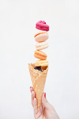lot of sweet meringue. Bright food photography of macroons on womans hand. French macaroon