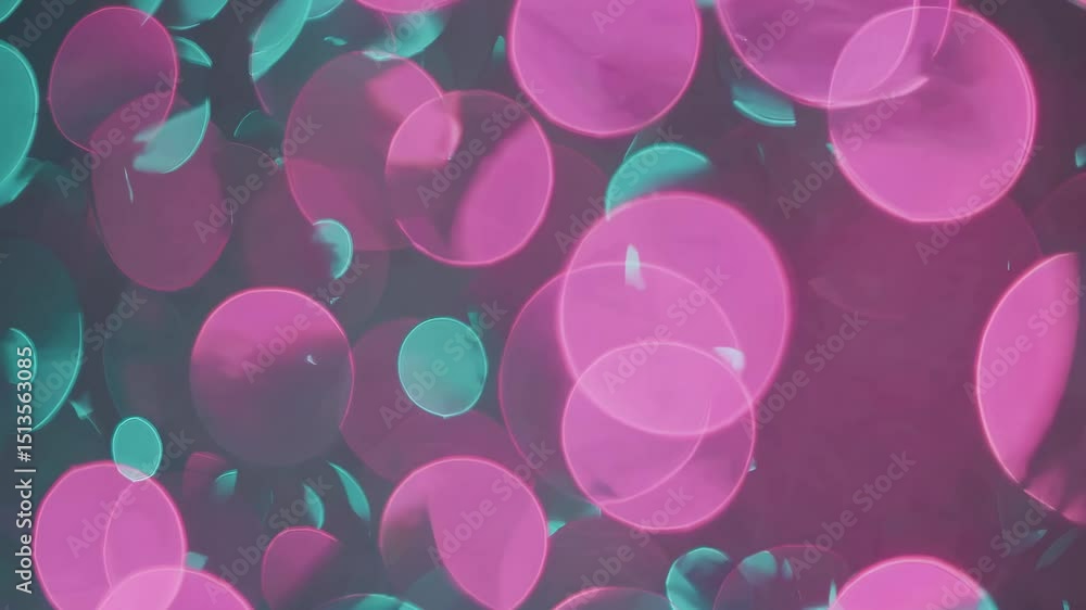 Poster pink and turquoise bokeh lights floating on a dark background creating a dreamy and magical atmosphe