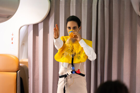 in-flight safety demonstration : Air hostess staff airline demonstrate. Cabin Crew or Steward staff airline demonstrate safety procedures to passengers. Flight attendant