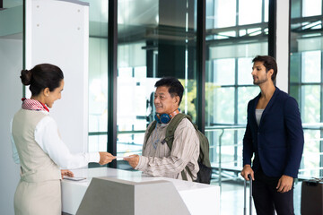 receptionist at desk in airport : Hispanic woman receptionist helping traveler with passport for...
