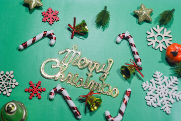 Elegant Christmas background with pink and gold decorations, including baubles, stars, and wrapped...