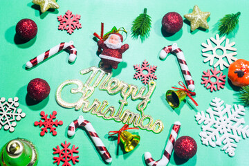 Elegant Christmas background with pink and gold decorations, including baubles, stars, and wrapped...