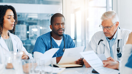 Fototapeta premium Man, doctors and meeting with documents at hospital, review and planning with report for virus. People, medical staff and teamwork with feedback, results and talk for solution in boardroom at clinic