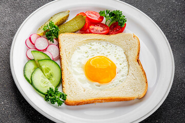Fried gashouse eggs in bread egg in the basket delicious snack breakfast in a bowl fresh delicious gourmet food background on the table rustic food top view copy space