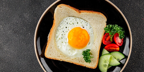 Fried gashouse eggs in bread egg in the basket delicious snack breakfast in a bowl fresh delicious gourmet food background on the table rustic food top view copy space