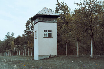 Historic guard tower stands amidst overgrown greenery in a forgotten location