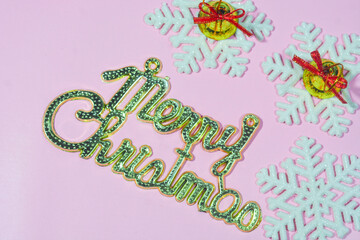 Elegant Christmas background with pink and gold decorations, including baubles, stars, and wrapped...