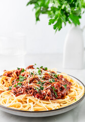 Pasta spaghetti with beef traditional bolognese sauce on white table