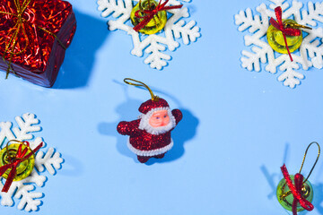 Elegant Christmas background with blue and gold decorations, including baubles, stars, and wrapped...