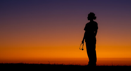 Silhouette of a Healthcare Professional at Sunset Contemplation and Resilience