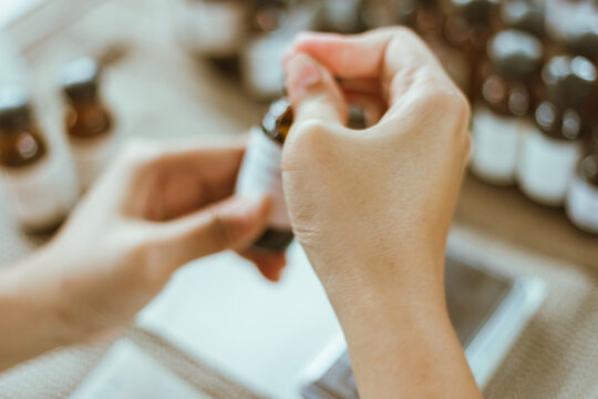 Shot of mature perfumer adding extra essential oil