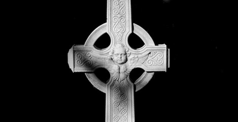 Angelic face sculpted on grave marker evokes eternity and remembrance within historical burial site