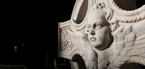 Spiritual cemetery sculpture depicting angelic guardian on a cross
