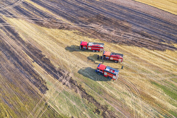 Three rescue vehicles arrived on an urgent call to extinguish a fire in a grain field