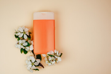 Shampoo, hair conditioner in a orange jar on a beige background. Mockup, space for text. White...