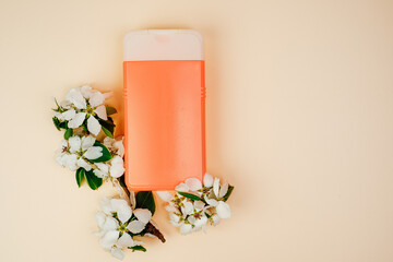 Shampoo, hair conditioner in a orange jar on a beige background. Mockup, space for text. White...