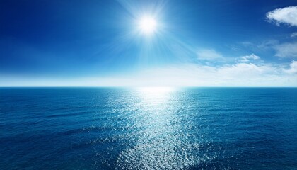 bright sun reflecting on the calm blue ocean at midday