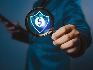 Businessman holding magnifying glass searching for financial security, secure online payment, digital banking, payment data protection, investment data protection on the internet