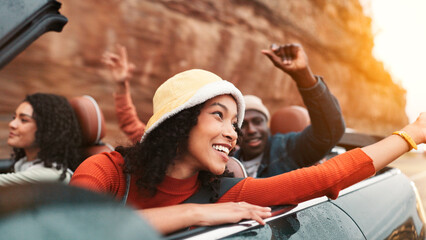 Dance, road trip and smile with happy people in car together for holiday, travel or vacation. Energy, freedom and thinking with group of friends riding in convertible vehicle for weekend getaway