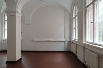 The interior of an empty and spacious room at Rauhankatu 13 in Helsinki, Finland, showcases...