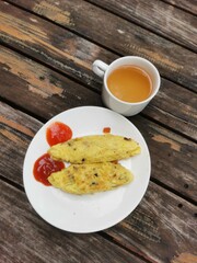 Breakfast Omelet and Tea on a Wooden Table.
Delicious healthy breakfast. Breakfast at the hotel.
Food photography concept.
Top view. Copy space.