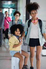 Obraz premium Family Passenger : African American sister and little girl traveling by an airplane. Diverse family travel in summer trip