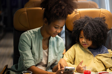 Passenger : African American sister and little girl traveling by an airplane