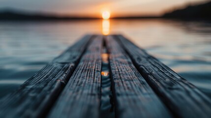 A peaceful sunset casting warm colors over a wooden dock, reflecting on the calm waters of a serene lake, inviting relaxation and introspection at twilight.