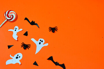 Background with a Halloween theme, with scary ghosts, lollipops and scary pumkins. October is the month of ghosts