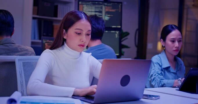 Diverse AI engineers working late in high-tech office, coding algorithms, analyzing data, and building intelligent systems. Focused teamwork and innovation drive future-ready software development. - Powered by Adobe