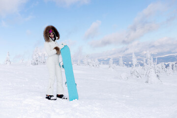 Woman snowboarder on the slopes on a frosty winter day