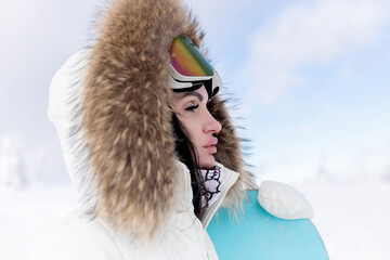 Woman snowboarder on the slopes on a frosty winter day