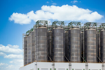 Row of large industrial silos for chemical petrochemical raw material storage, Storage silos in industrial modern industry, Industrial storage tank silos.