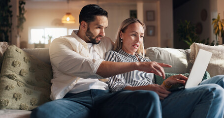 Couple, laptop and relax on sofa in home with point, talk and choice for film, streaming or series....