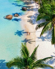 Relaxing couple on a serene tropical beach with crystal clear waters in the Caribbean