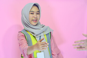 Young Asian woman an attractive young female construction worker working. Carrying a map,...