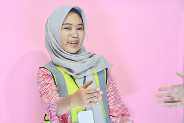 Young Asian woman an attractive young female construction worker working. Carrying a map,...