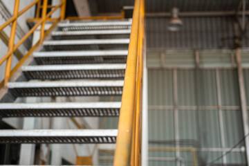 Banister handrail with yellow painting of stairway platform at the factory place. Industrial...