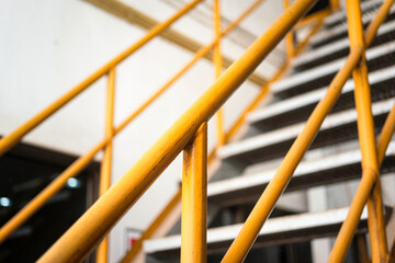 Banister handrail with yellow painting of stairway platform at the factory place. Industrial...