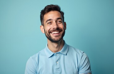 Plakat Portrait of cheerful man 30s wearing sporty polo shirt against pastel blue background. Happy male with stylish hairstyle smiles broadly. Perfect white teeth. AI generated image suitable for marketing