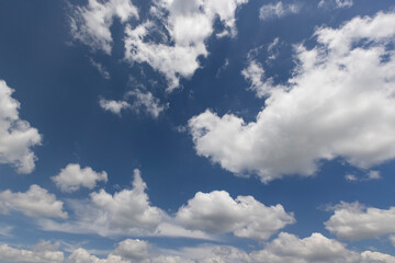 blue sky with clouds , blue sky with cumulus clouds illuminated by sun