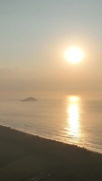 Florianopolis in Santa Catarina during a wonderful sunrise. Mo&ccedil;ambique Beach in aerial view, vertical video.