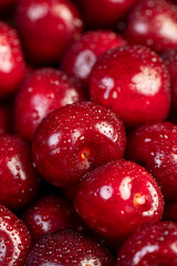 cherry in drops of water, wet red cherry fruits on the kitchen table