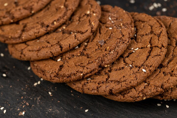 round chocolate biscuits with white sesame seeds and cocoa powder