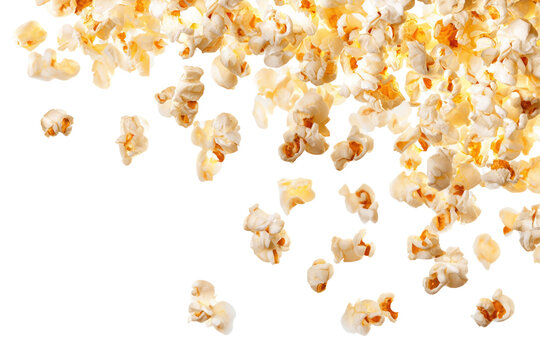 A close up shot of popcorn pieces scattered on a black background in a studio setting with bright lighting